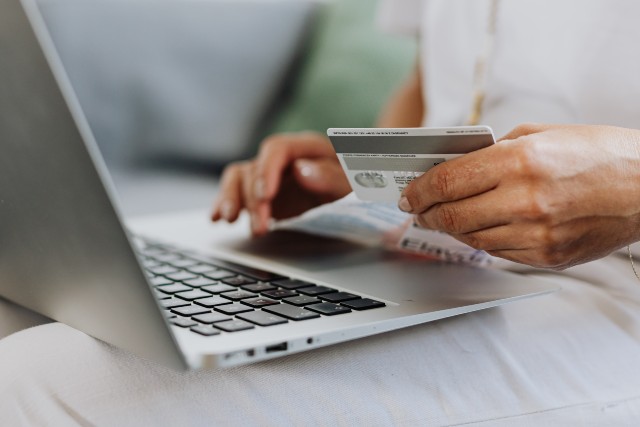 person using credit card on laptop