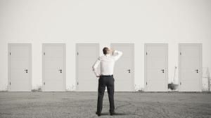 Man standing in front of 6 doors